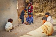 Group of children playing with pebbles in Jalalpur Pirwala, Punjab.