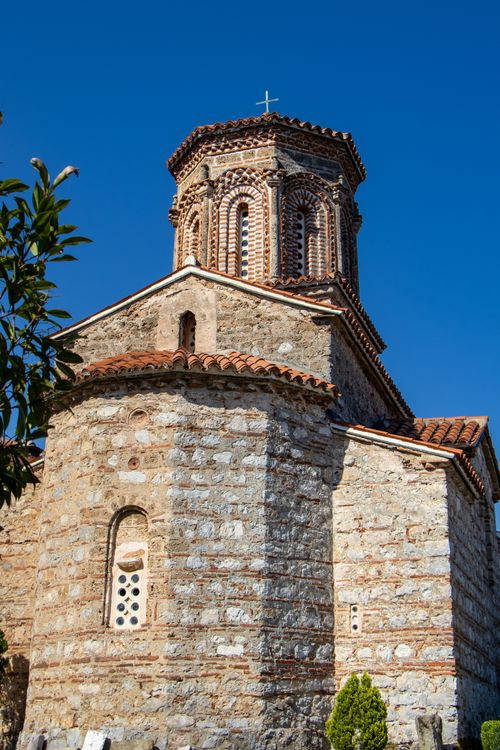 Free A stunning view of a historic Byzantine church tower against a clear blue sky, showcasing intricate brickwork and architectural charm. Stock Photo