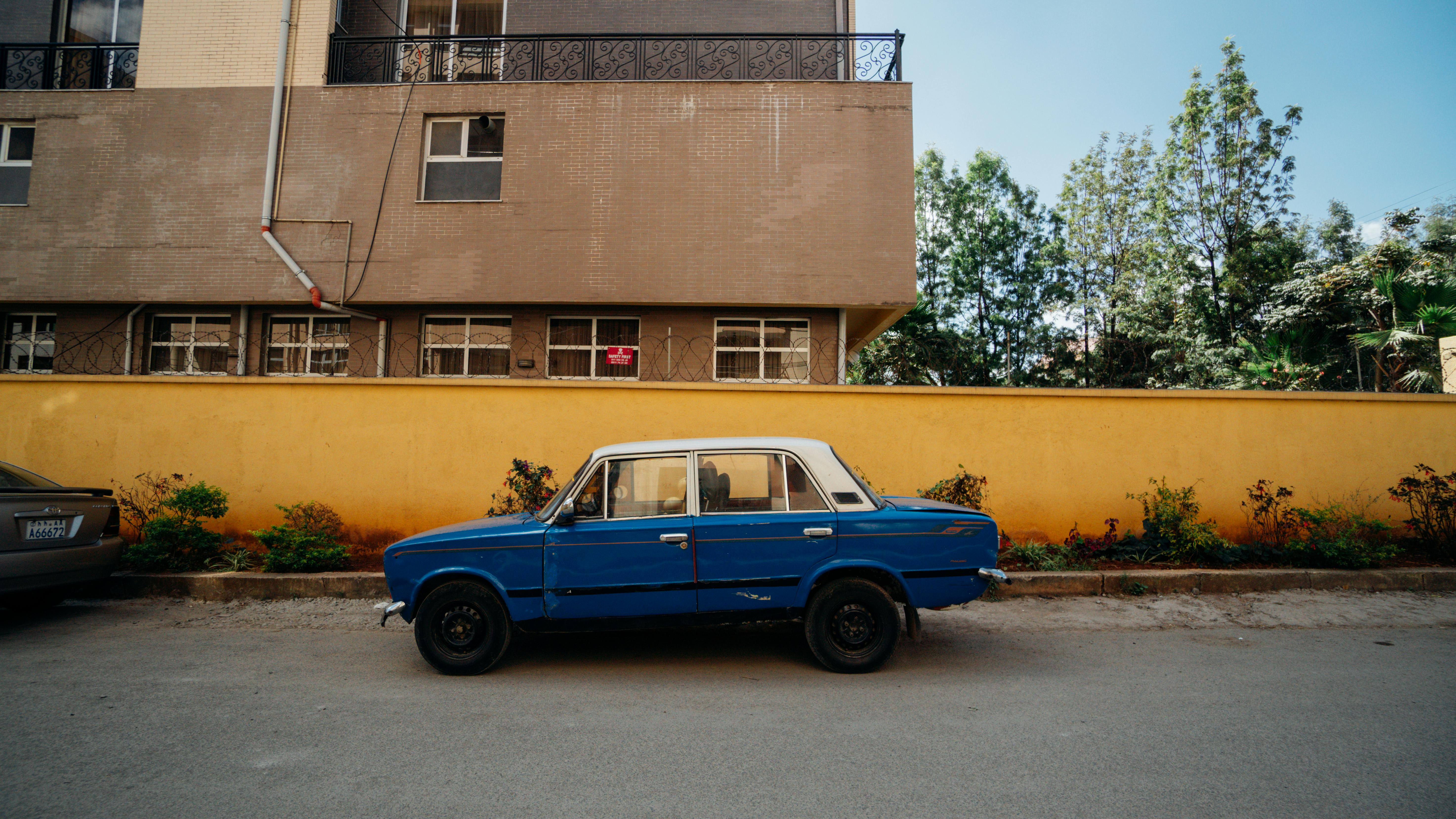 photo of blue sedan on street