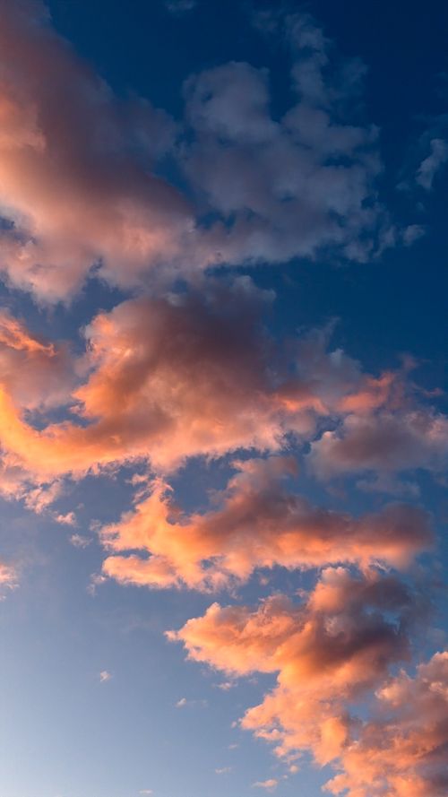 Free Captivating view of colorful clouds during sunset against a clear blue sky, creating a serene and dramatic visual. Stock Photo
