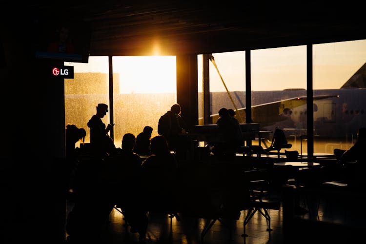 Silhouette Of People Sitting Inside The Airport