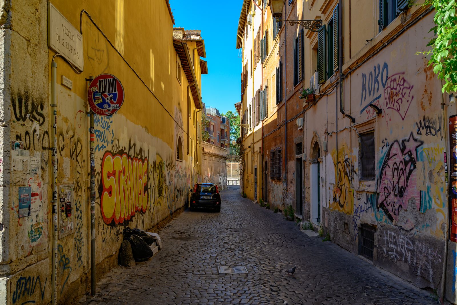 A Trastevere backstreet before the evening crowd arrives, laundry lines overhead.