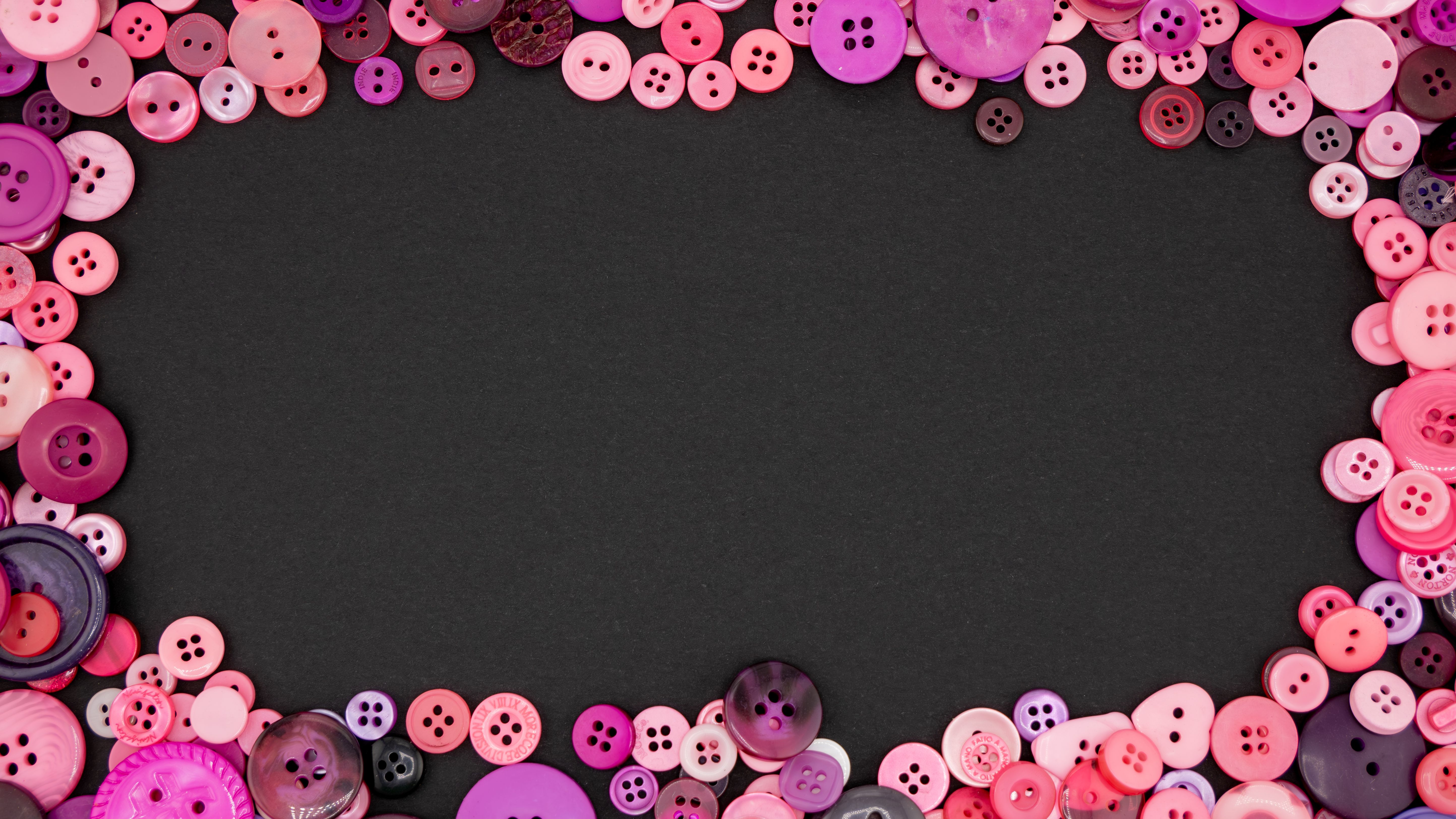 Assorted colorful buttons arranged around a black background, perfect for DIY projects.