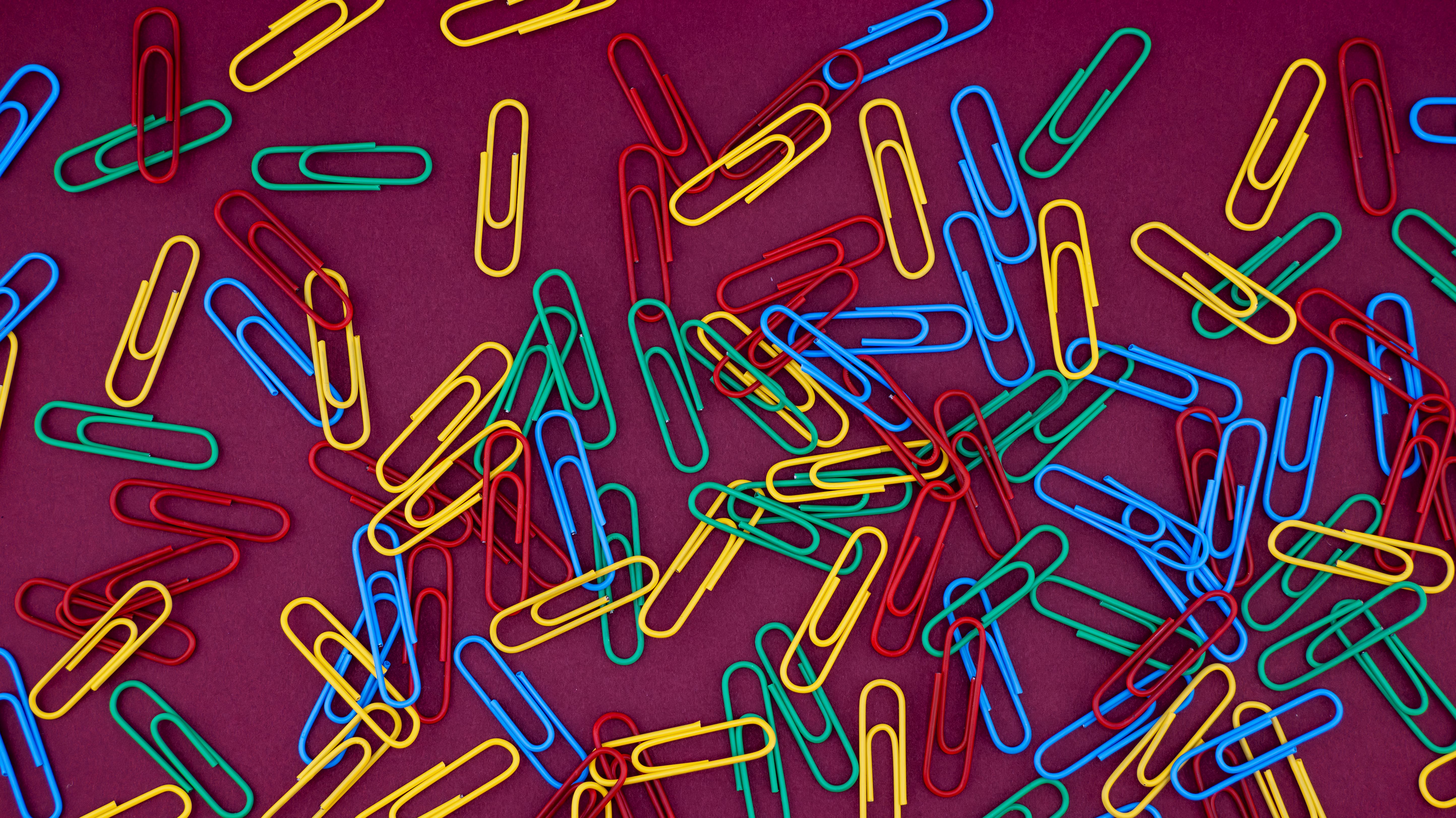 Colorful Paper Clips on Purple Background · Free Stock Photo