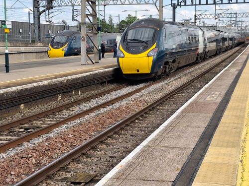 Free A high-speed train arrives at Birmingham station on a clear day, showcasing travel infrastructure. Stock Photo