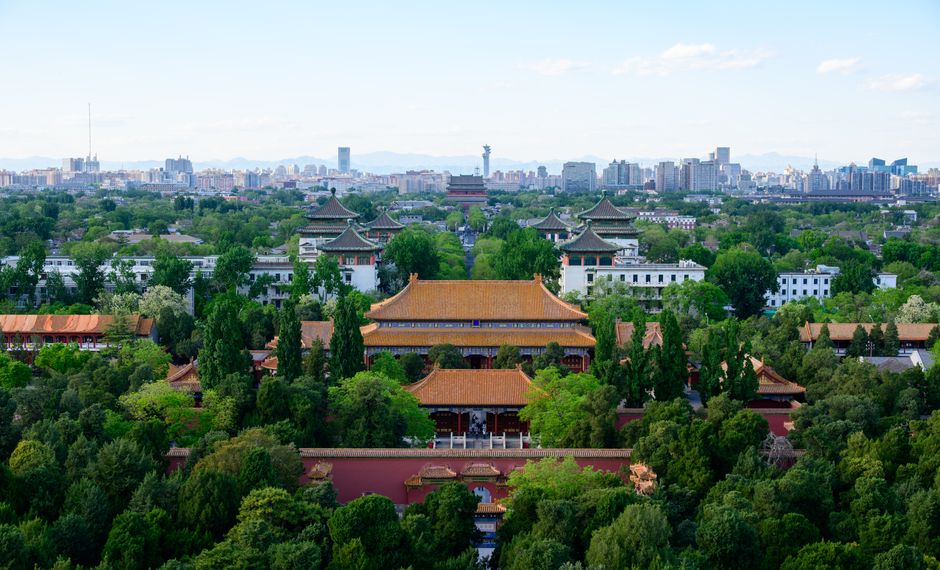 Amazing Mutianyu Great Wall Hiking and Helicopter Tour with Transfers Review 2026 - A stunning aerial view of ancient Chinese architecture with Beijing's city skyline in the background.