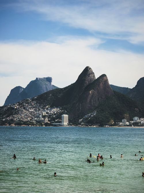 Free Swimming in vibrant waters with iconic mountains of Rio de Janeiro in the backdrop. Stock Photo