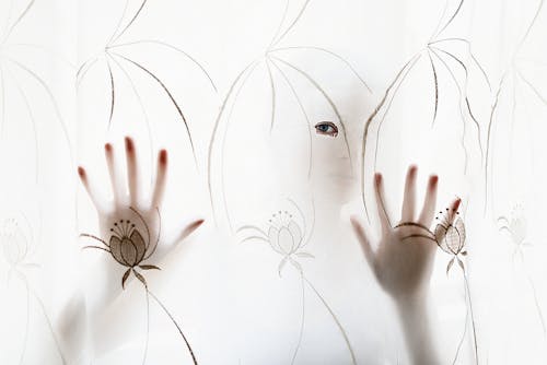 Person Holding Brown Flower Curtain