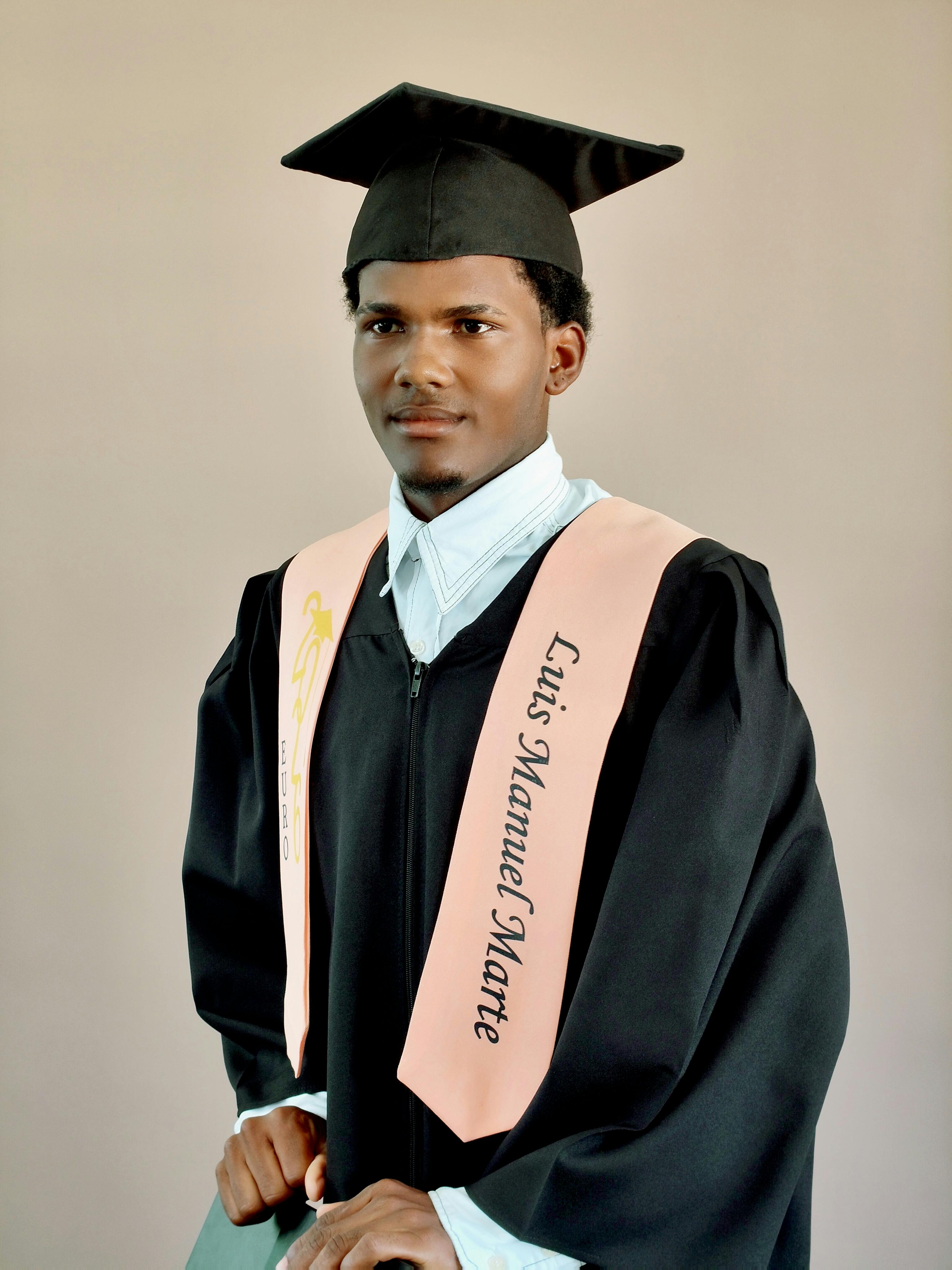 Portrait of a young graduate proudly wearing a cap and gown signifying academic achievement.