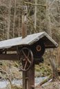 Shabby well in woodland in countryside