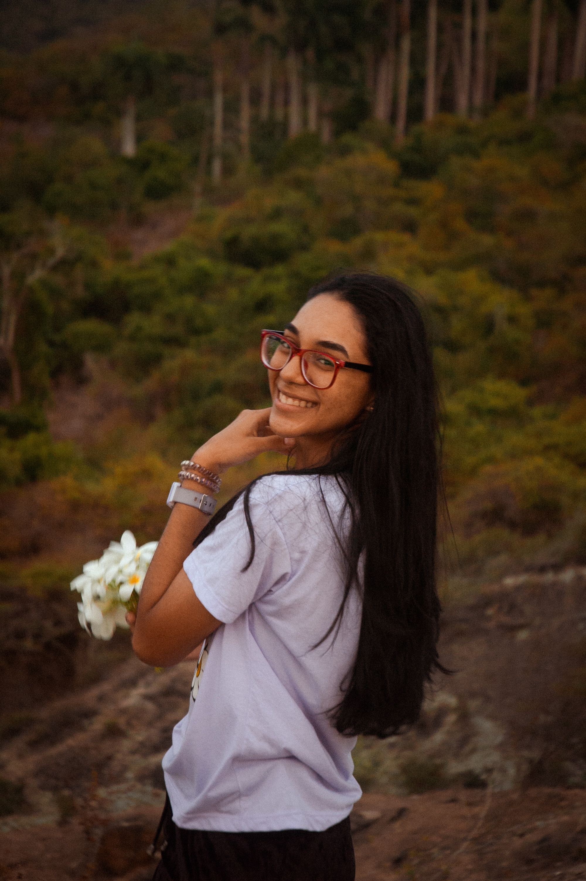 Woman Smiling Outdoors in Nature Setting · Free Stock Photo