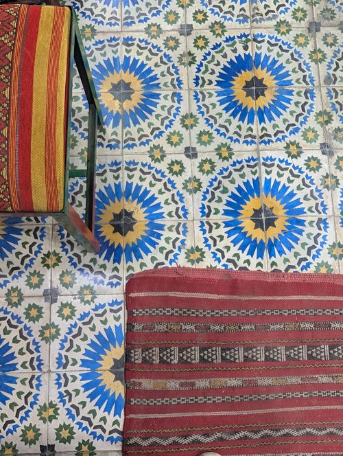 Free Vibrant Moroccan tile floor with traditional rugs. Perfect for home decor inspiration. Stock Photo