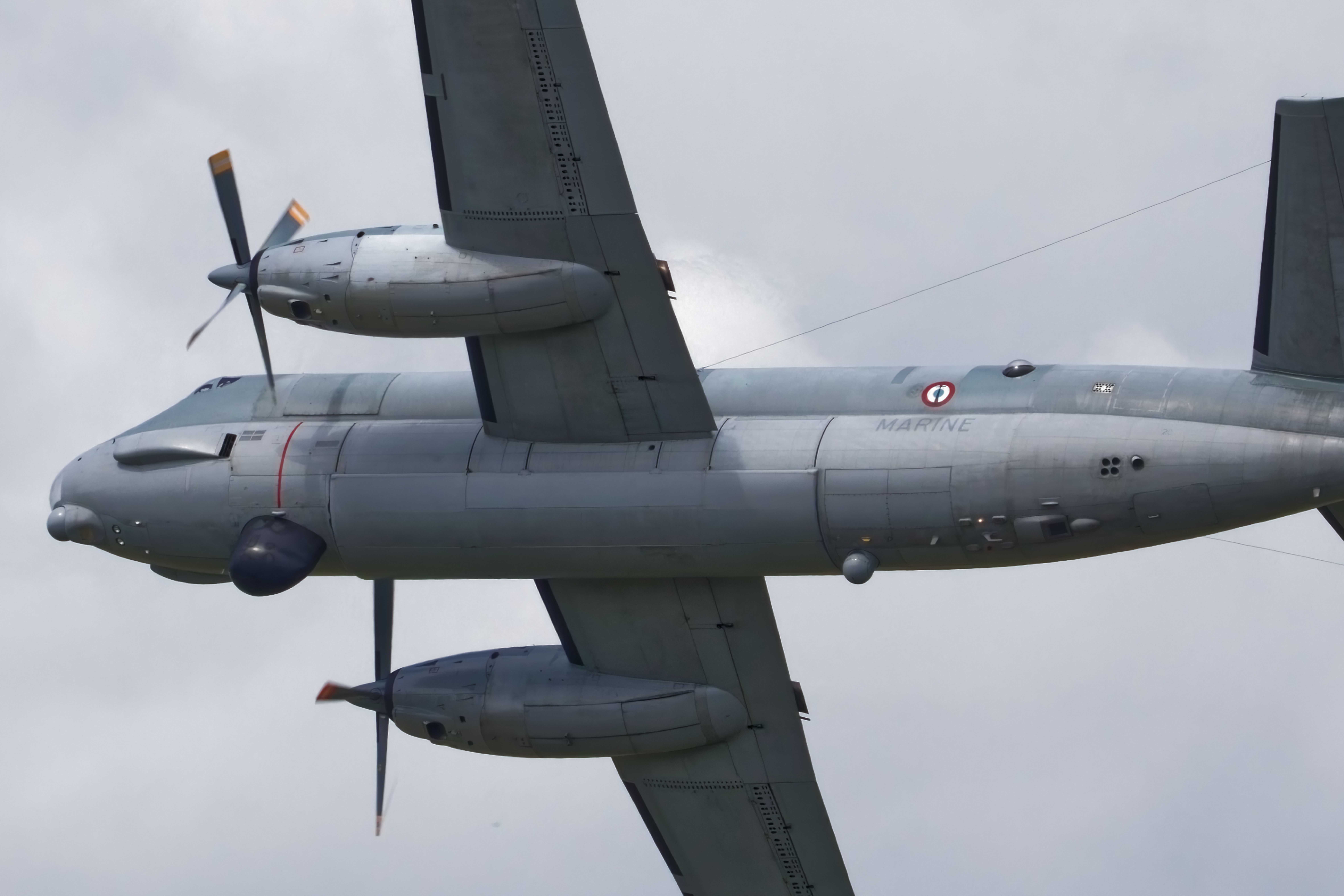Military Aircraft Flying Overhead in Cloudy Sky · Free Stock Photo