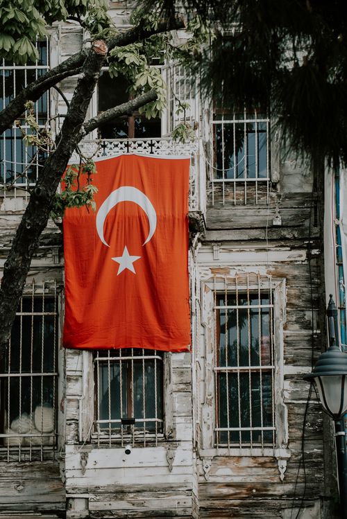 Free Old building in Istanbul with a Turkish flag hanging, showcasing cultural pride. Stock Photo