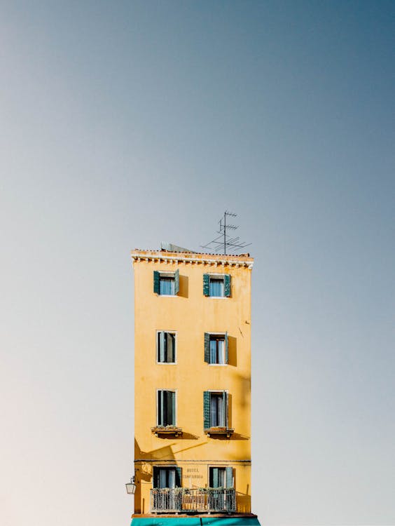 Yellow Apartment Building Under Blue Sky