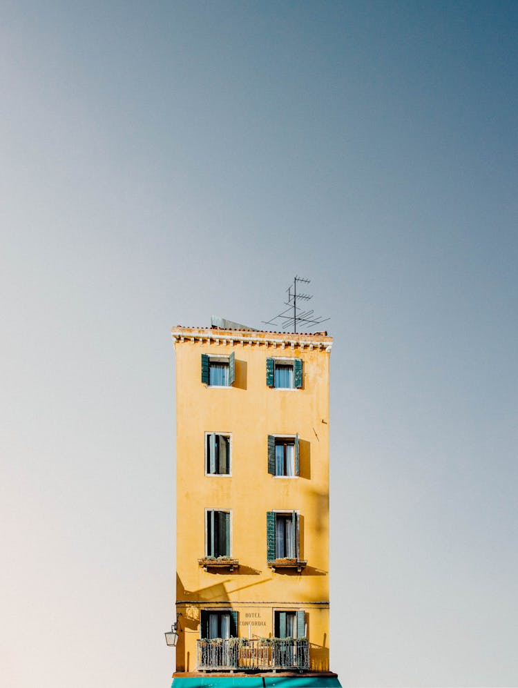 Yellow Apartment Building Under Blue Sky