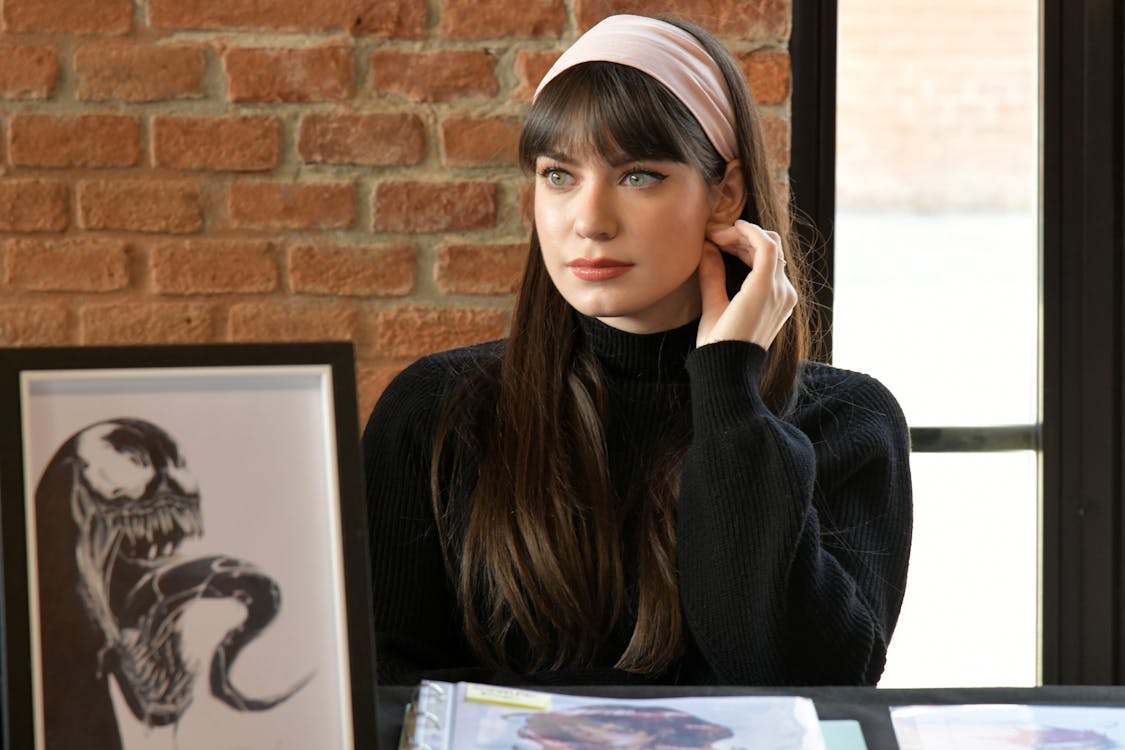 Woman in Black Sweater Sitting on Chair