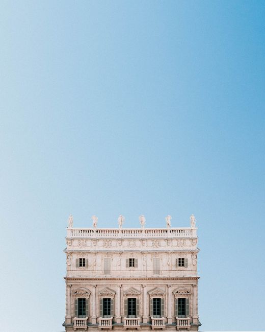 Minimalist architectural shot featuring a historical building facade against a clear blue sky, perfect for backgrounds.
