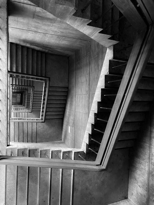 Free Monochrome view of a spiral staircase in Dhaka, showcasing intricate symmetry. Stock Photo