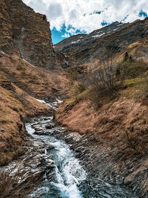 Free Captivating mountain stream flowing through the rocky landscape in Glarus Süd, Switzerland. Stock Photo