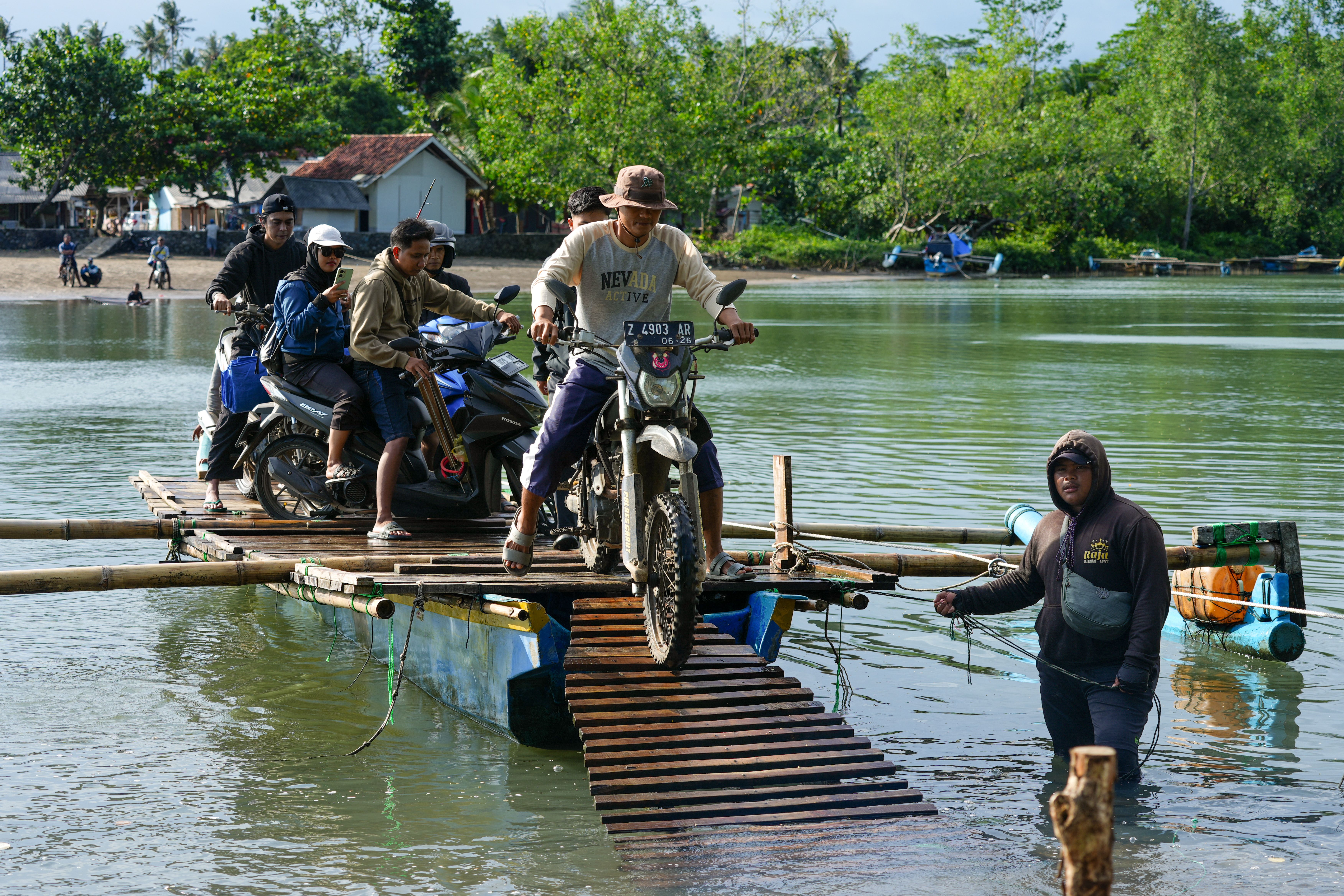 Motorcyclists Crossing Riverside Bamboo Raft in Indonesia · Free Stock ...