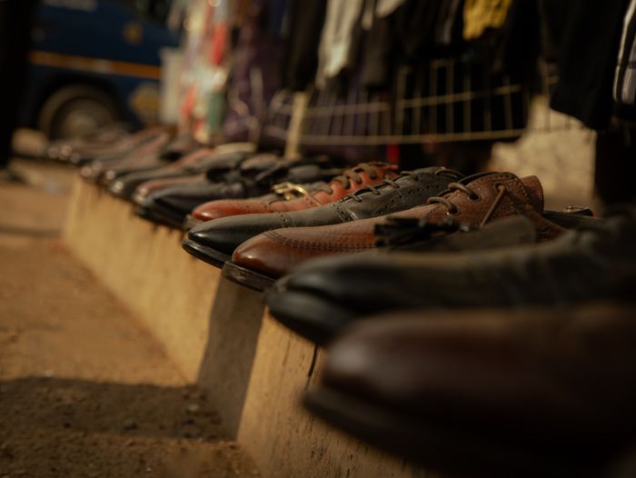 Close-up of brown leather shoes lined up at an outdoor market stall. — photo by Xlenz  Creatives on Pexels