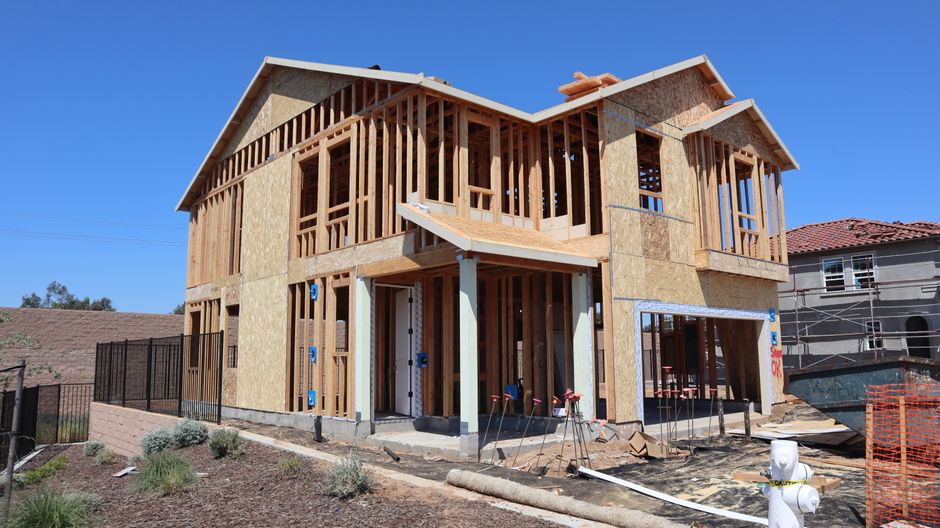 A newly framed partial second story addition built over an existing ground-floor garage A newly framed partial second story addition built over an existing ground-floor garage