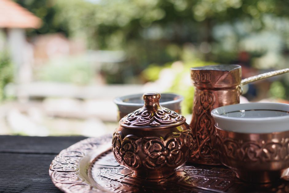 Delicious traditional Bulgarian banitsa pastry with a cup of coffee on a table.