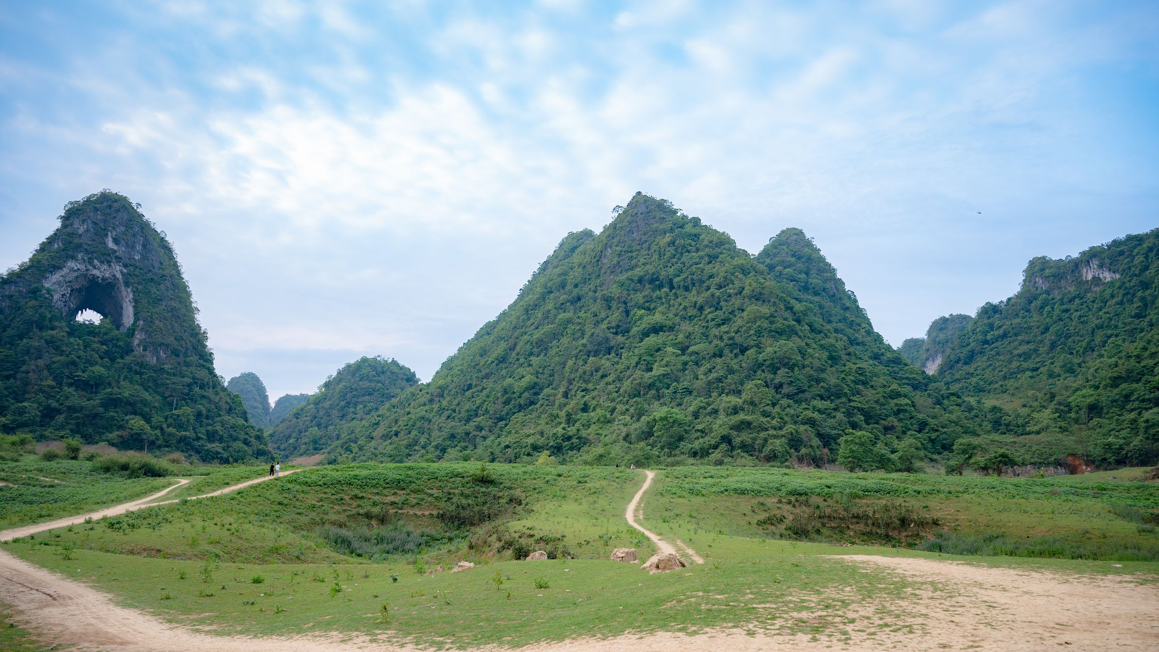 Stunning view of lush green mountains in Tra Linh, Cao Bang, Vietnam, under a vibrant sky.