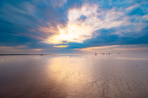 Free Beautiful sunset over the beach in Thai Binh, Vietnam showcasing vibrant colors and reflections. Stock Photo
