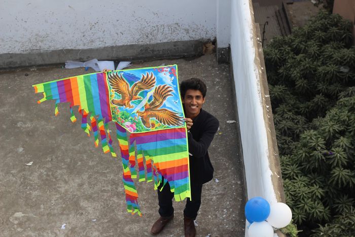 Festive kite flying moment on an Indian rooftop during Sankranti