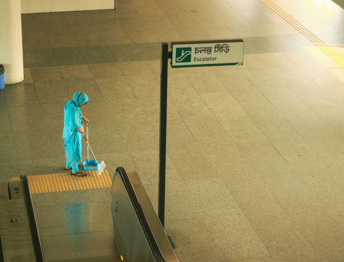 Free A woman cleans the floor at a metro station in Dhaka, Bangladesh, showcasing everyday life and urban cleanliness. Stock Photo