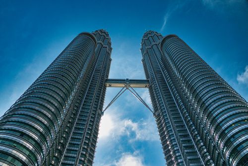 Free A vibrant view of the iconic Petronas Towers against a clear blue sky in Kuala Lumpur, Malaysia. Stock Photo