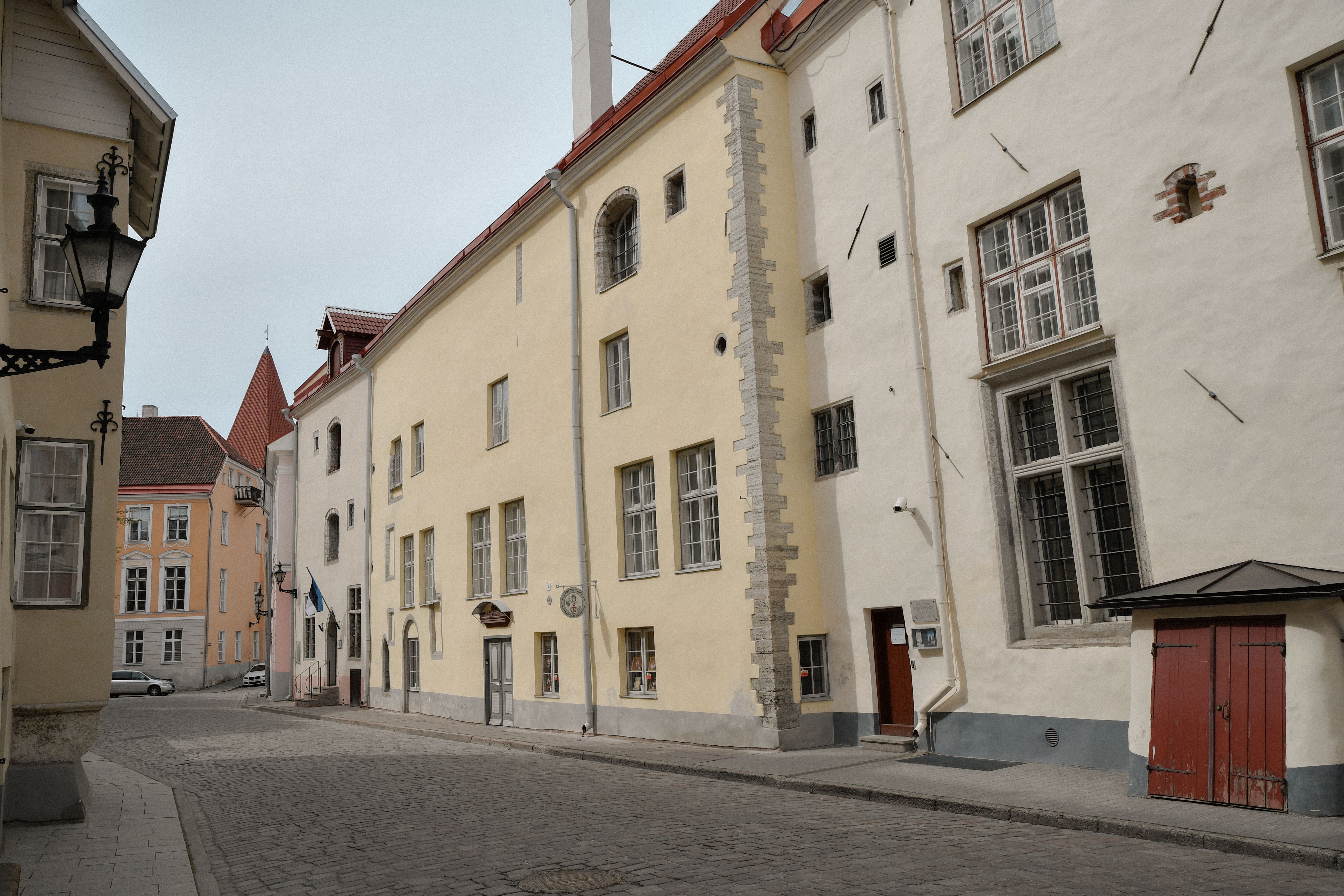 Tourists walking safely through the charming cobblestone streets of Tallinn Old Town, Estonia