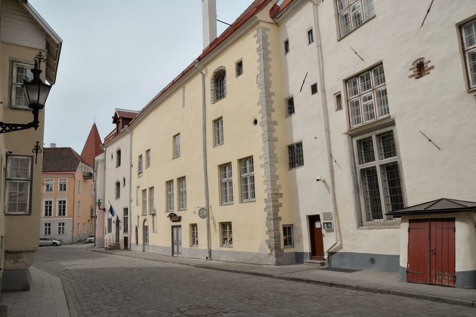 Tourists walking safely through the charming cobblestone streets of Tallinn Old Town, Estonia