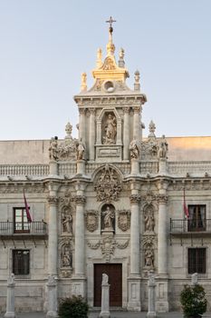 Detailed view of the ornate facade of the University of Valladolid in Spain, showcasing Baroque architecture.