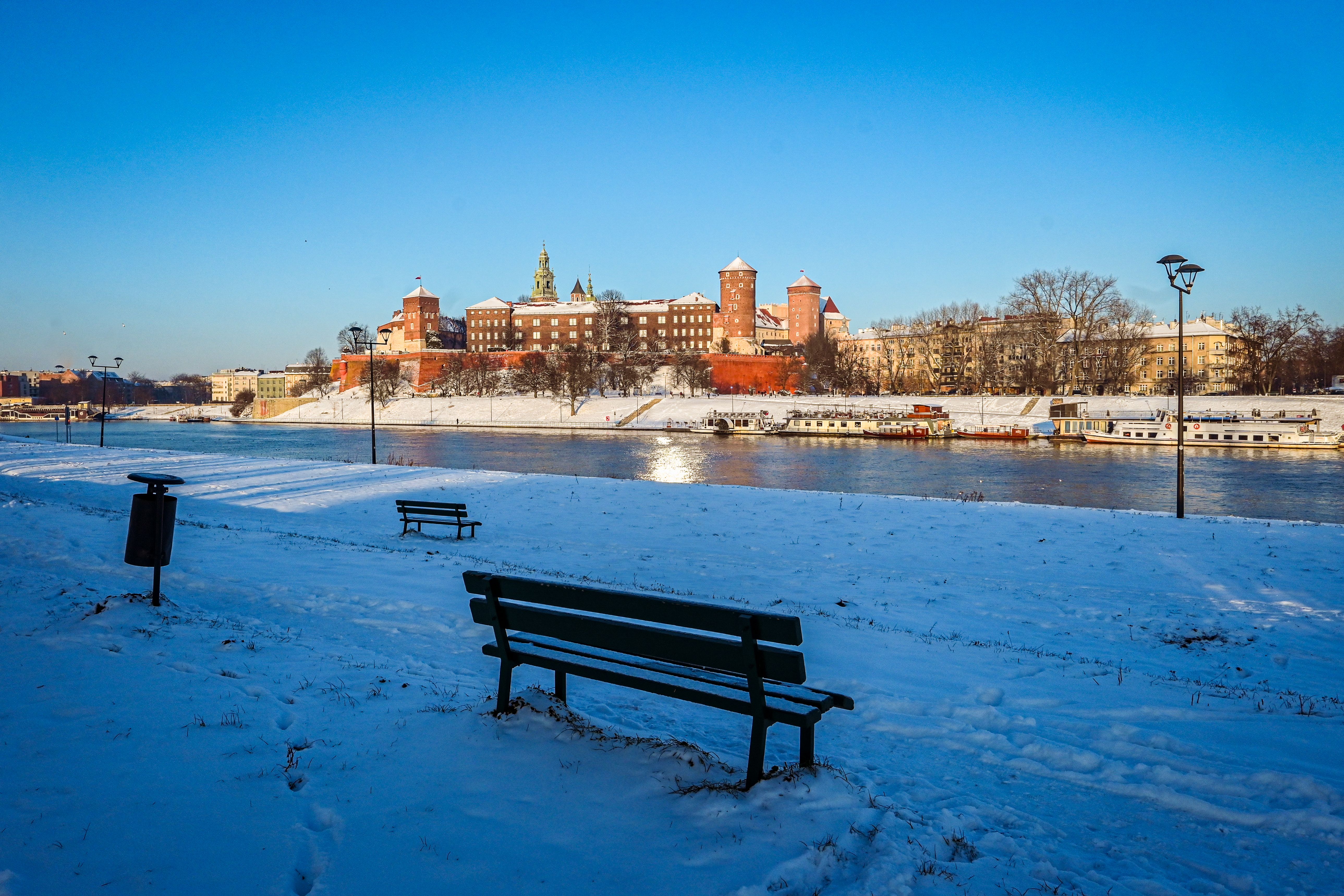 The majestic Wawel Royal Castle in Krakow, Poland, under a clear sky, with its historic walls and towers.