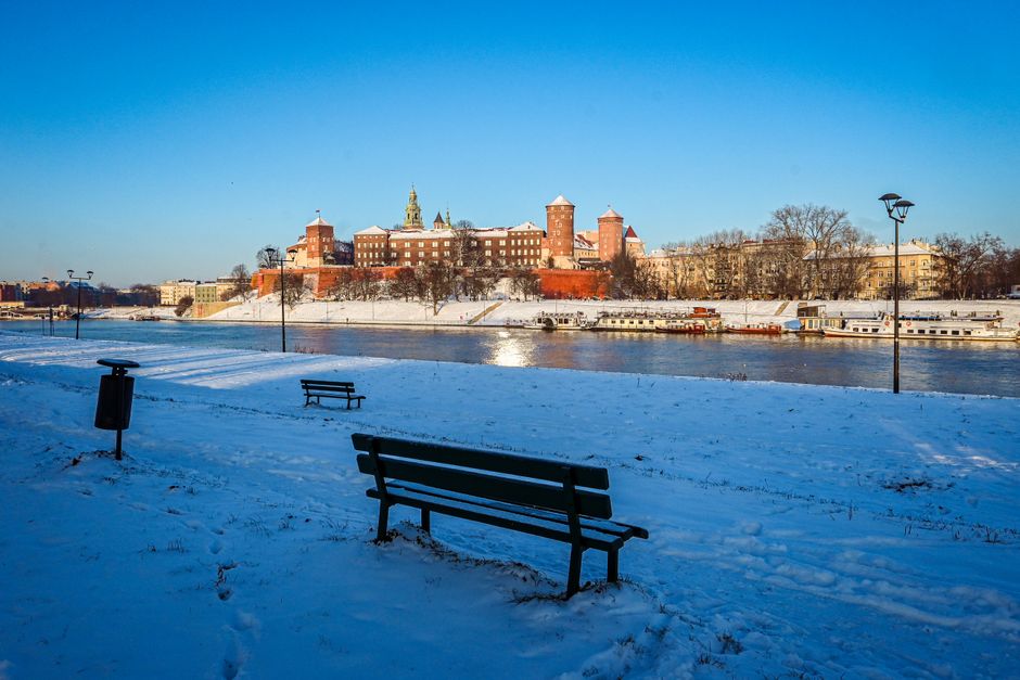 The majestic Wawel Royal Castle in Krakow, Poland, under a clear sky, with its historic walls and towers.