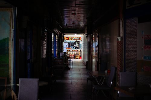 Free Moody indoor alley in Ankara leading to a colorful and inviting cafe entrance. Stock Photo