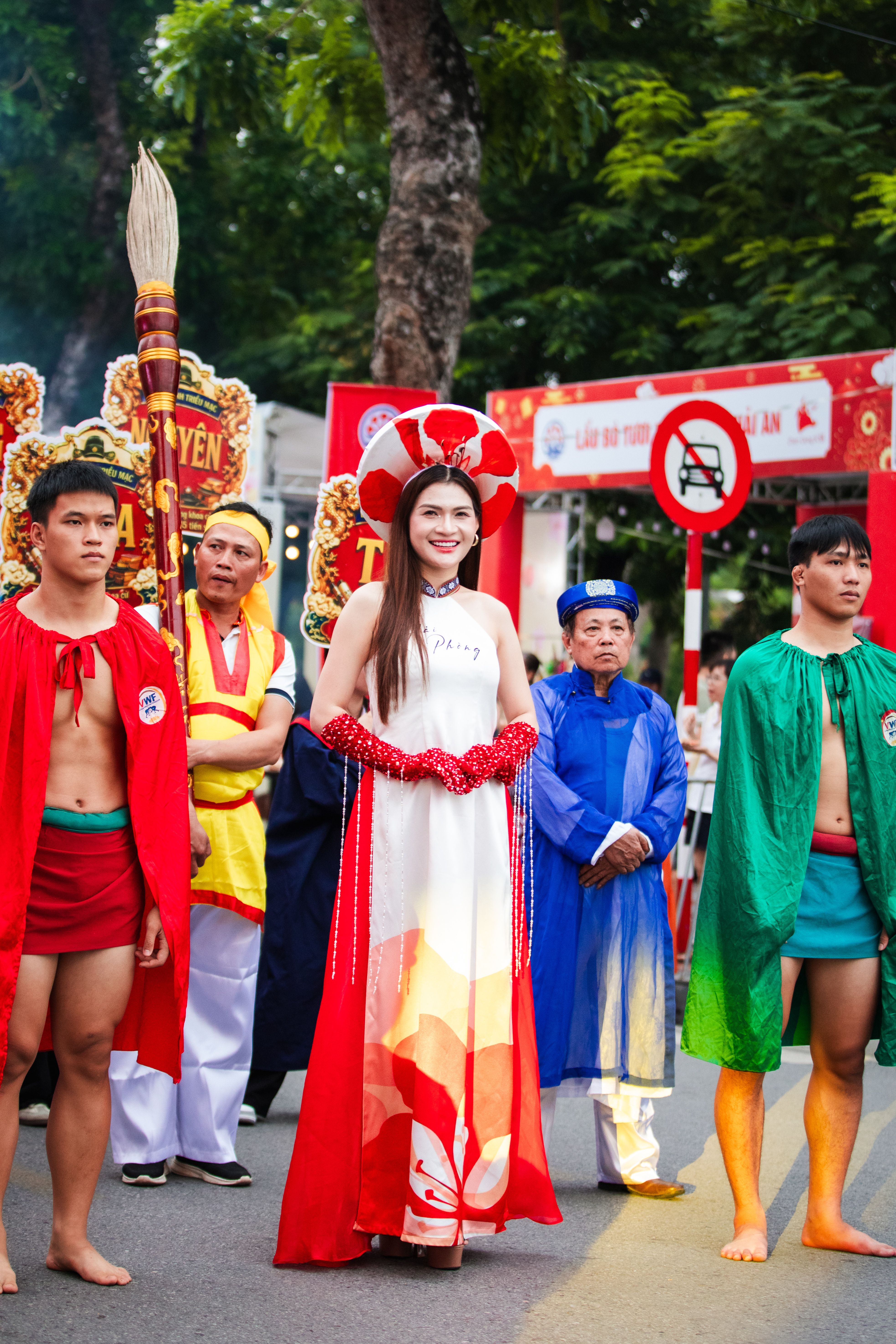 Vibrant traditional parade with performers in cultural attire in Haiphong, Vietnam.