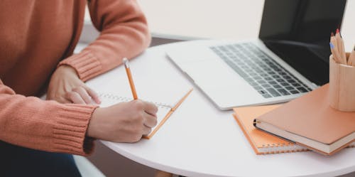 Person Writing on White Paper