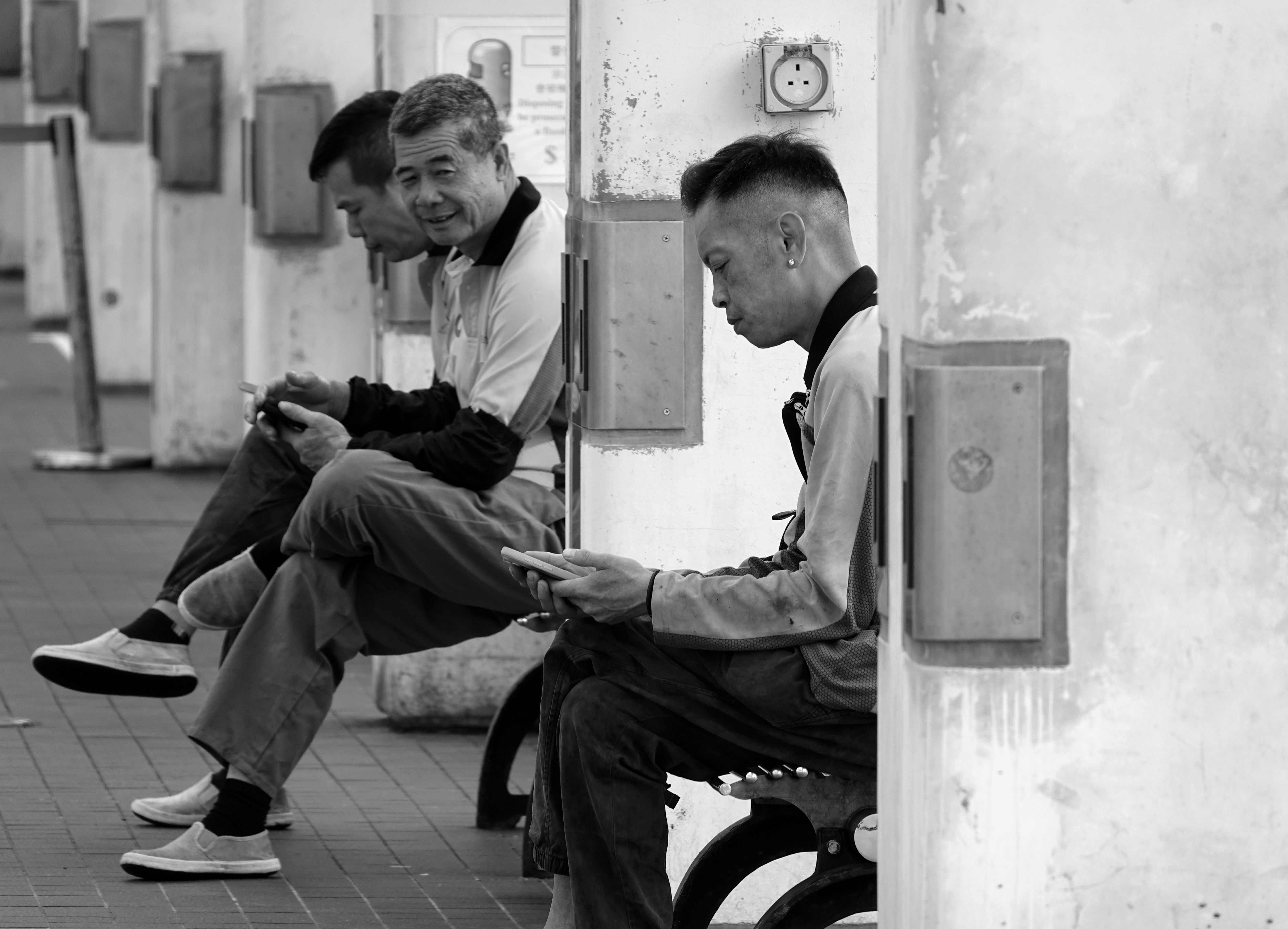 Hong Kong racegoers studying printed racecards beside the Happy Valley paddock