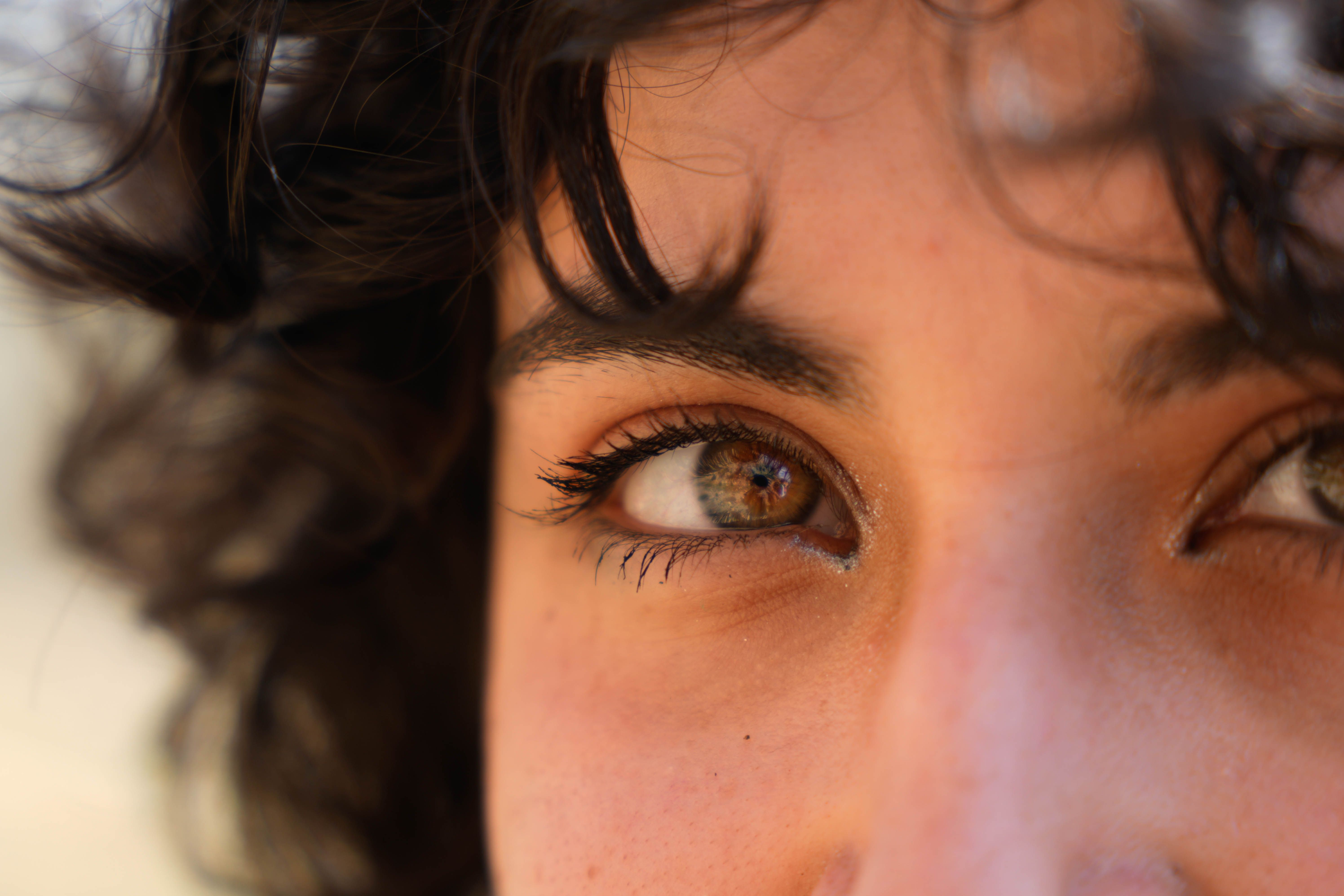 An artistic close-up image capturing the vivid detail and natural beauty of eyes with reflective light.