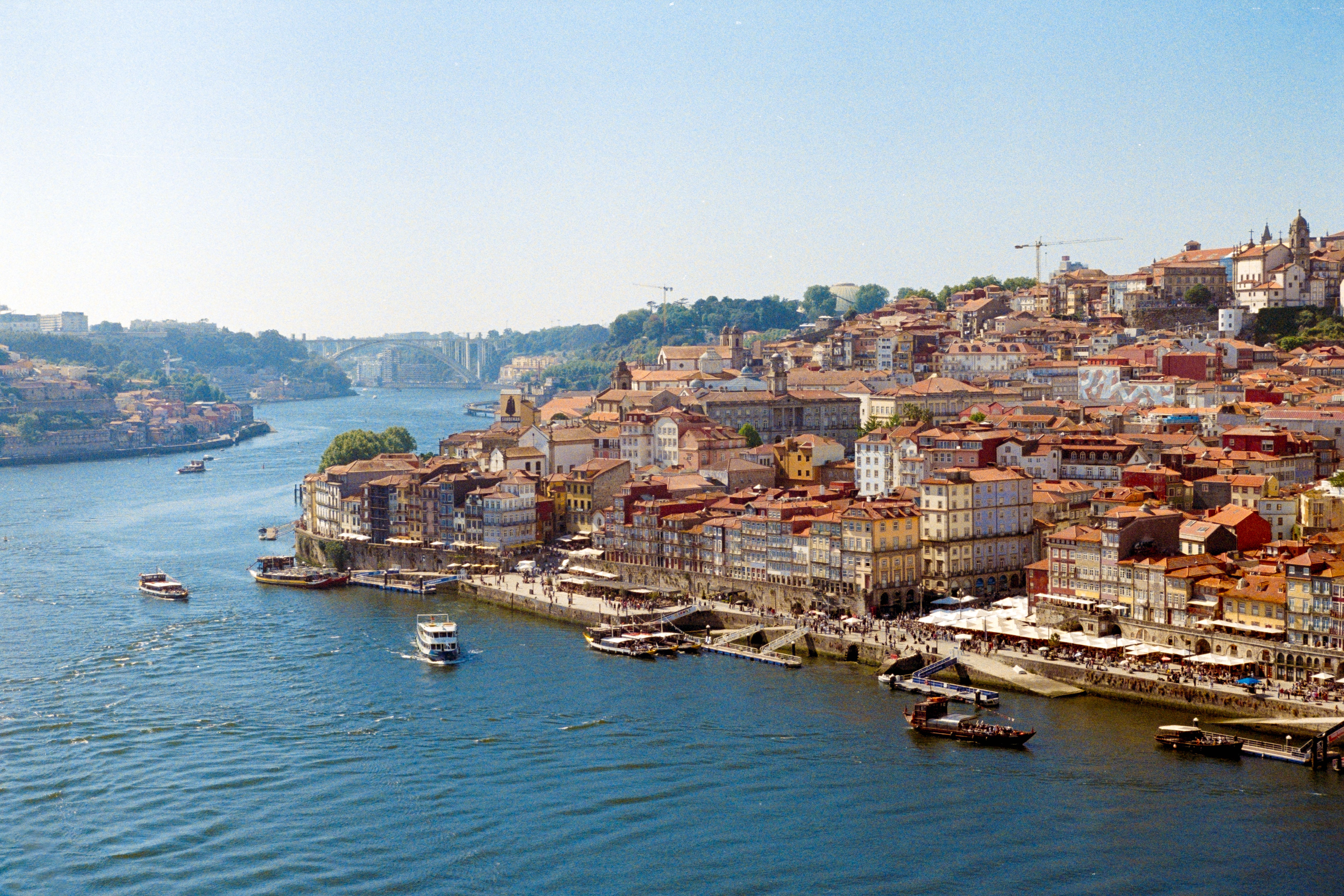 Captivating aerial view of Porto's colorful riverside architecture along the Douro River.