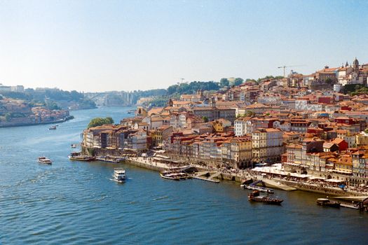Captivating aerial view of Porto's colorful riverside architecture along the Douro River.
