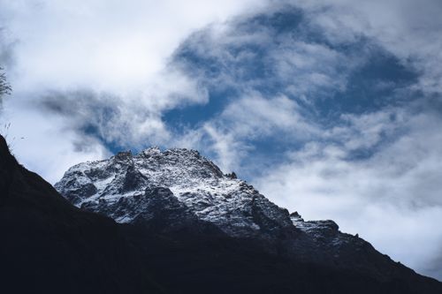Free Breathtaking view of a snow-capped mountain peak in Kedarnath, India, set against a dramatic cloudy sky. Stock Photo