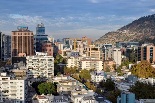Free Aerial view of Santiago's modern skyline with the Andes mountains in the background. Stock Photo
