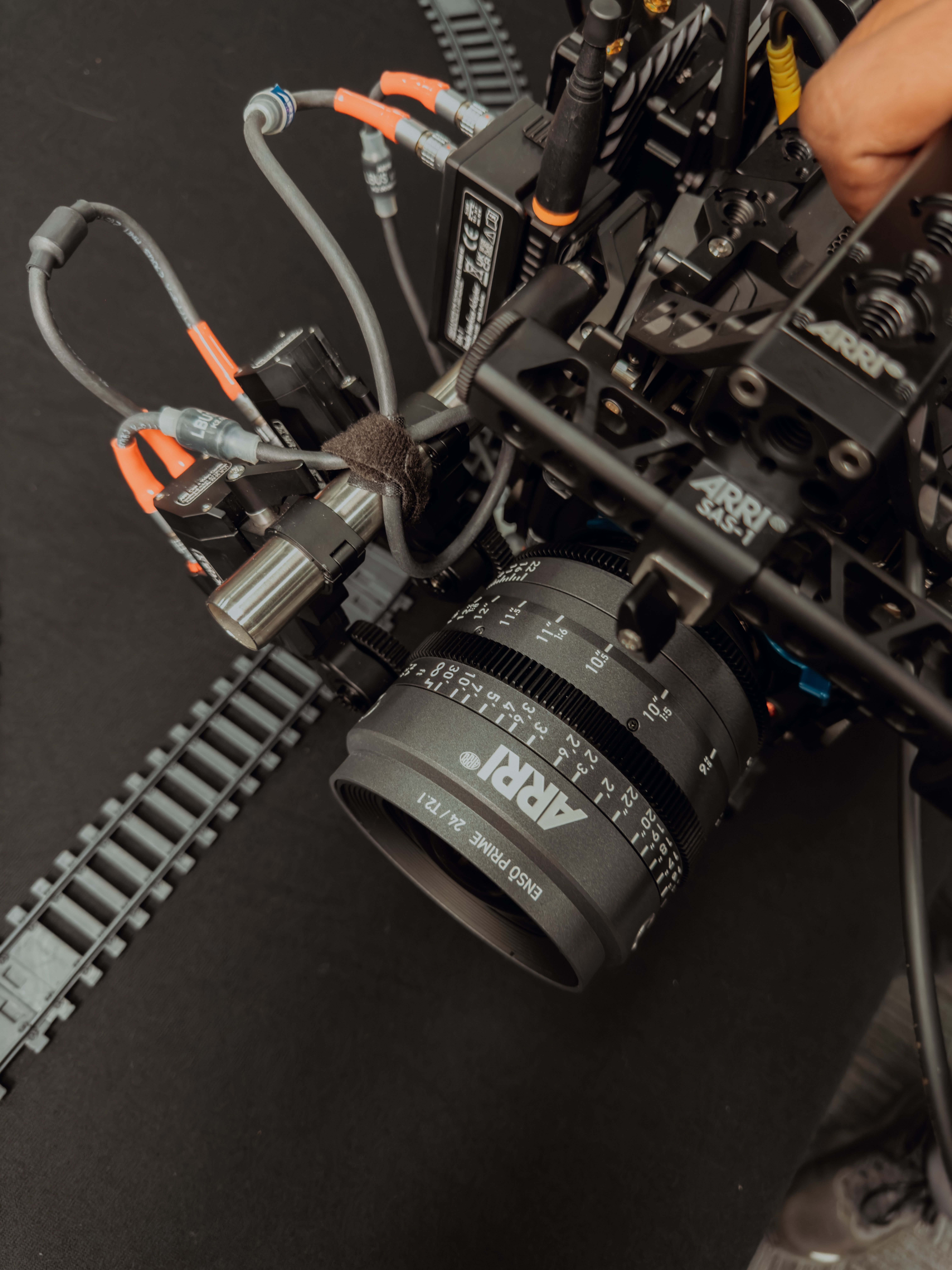 Detailed view of high-end camera setup with cables, gear, and ARRI lens.