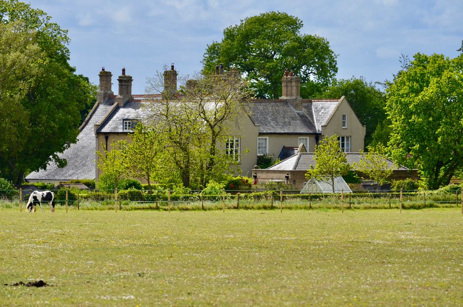 Countryside English house in lush greenery representing a typical UK property estate that may benefit from the 36% reduced inheritance tax rate