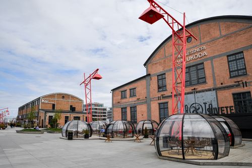 Free Outdoor dining pods and industrial architecture create a unique urban atmosphere in Tallinn, Estonia. Stock Photo